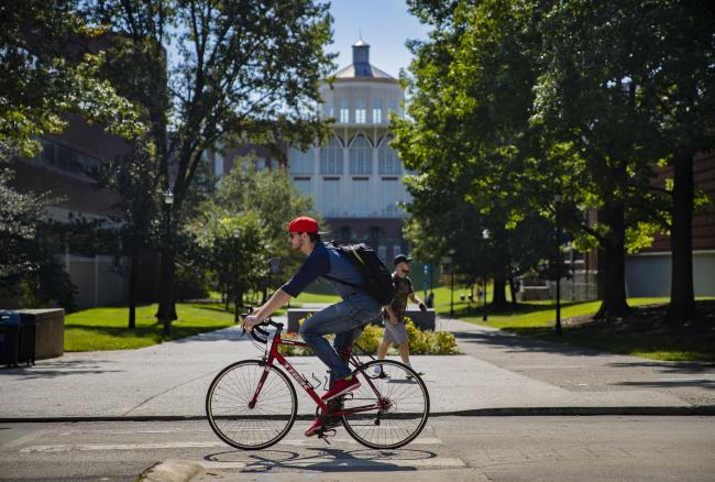 Students going to class, on a bike