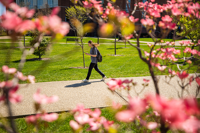 Student walking during spring