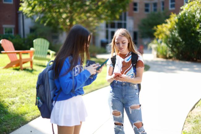 Students on their phones on campus